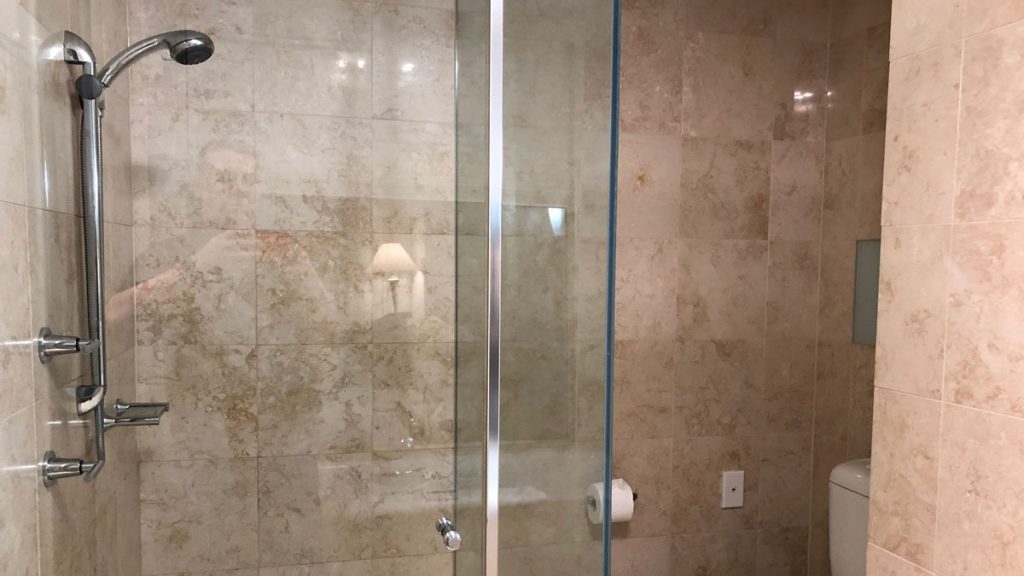 a glass shower door in a bathroom