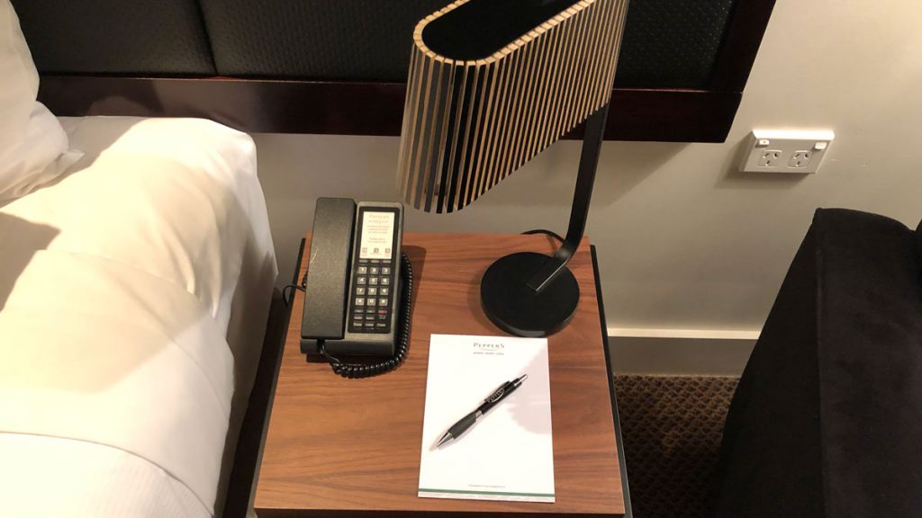 a telephone and a pen on a table