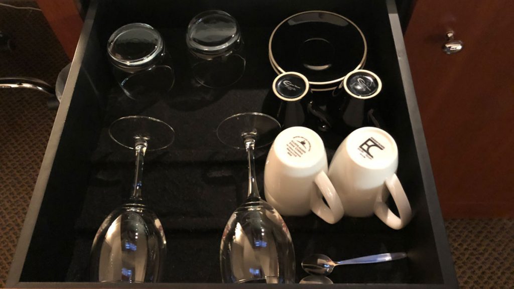 a tray with glasses and cups