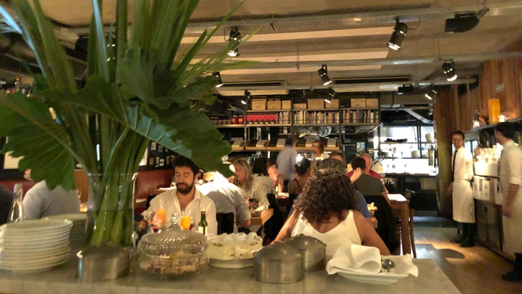 a group of people sitting at a table in a restaurant