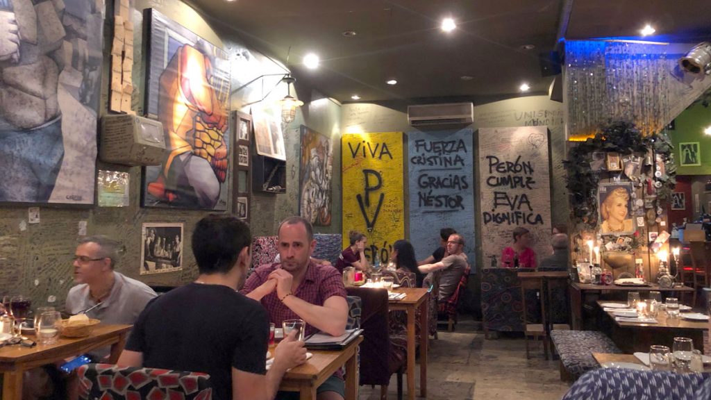 a group of people sitting at tables in a restaurant