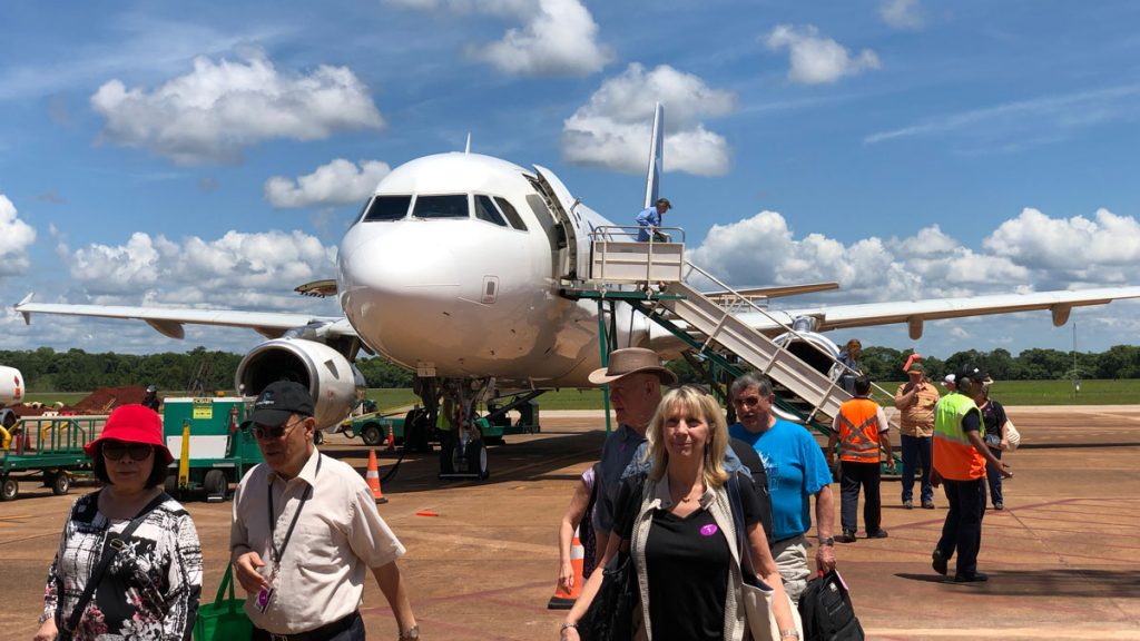 a group of people walking by an airplane