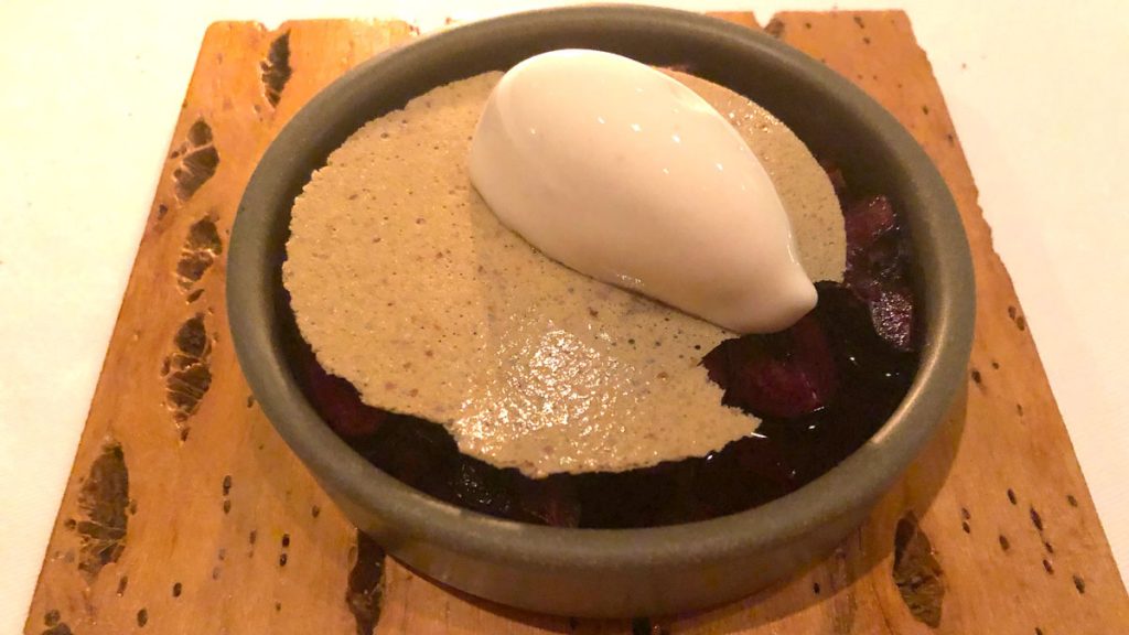 a bowl of food with a white object on top