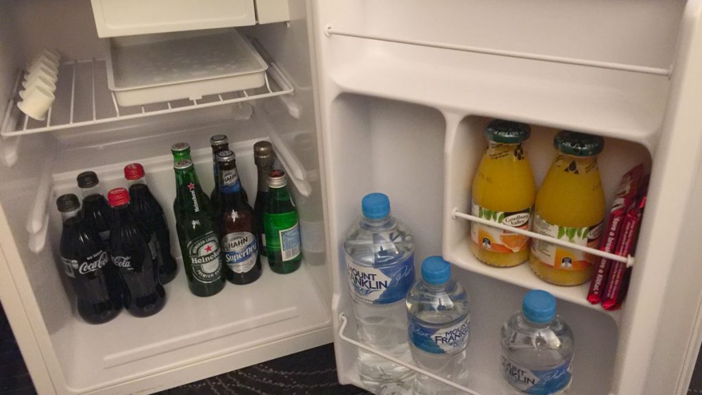 a refrigerator with bottles of beverages