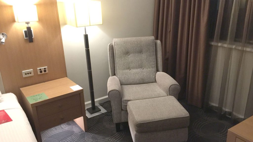 a chair and a lamp in a room