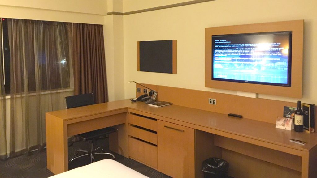 a room with a desk and a tv