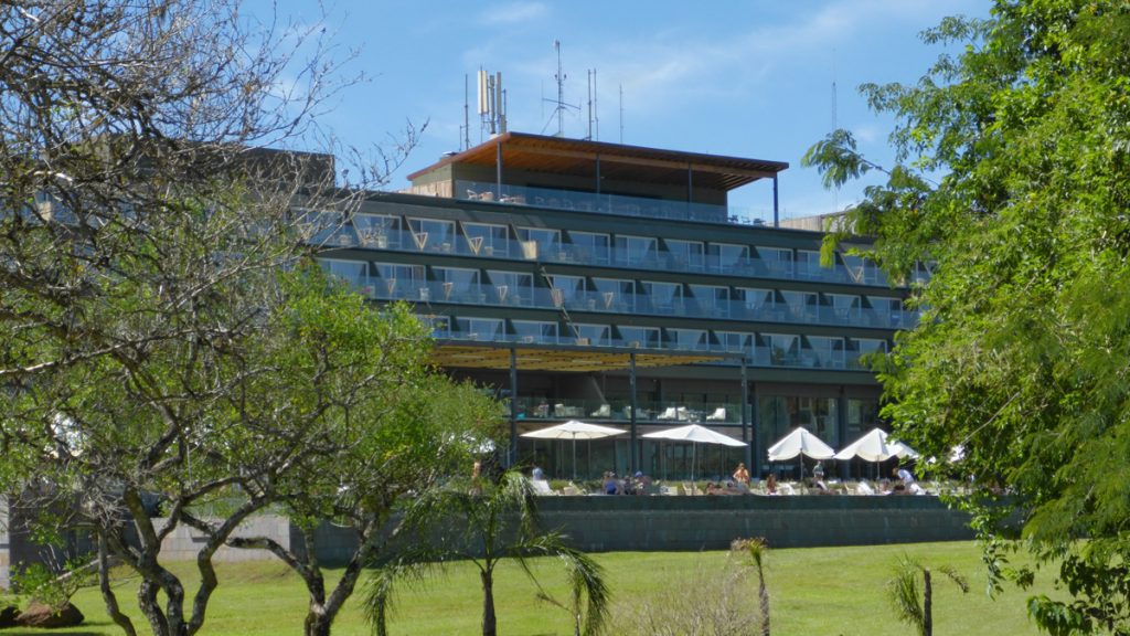 a building with many windows and a lawn