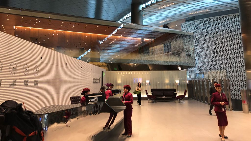 a group of people standing at a desk in a lobby