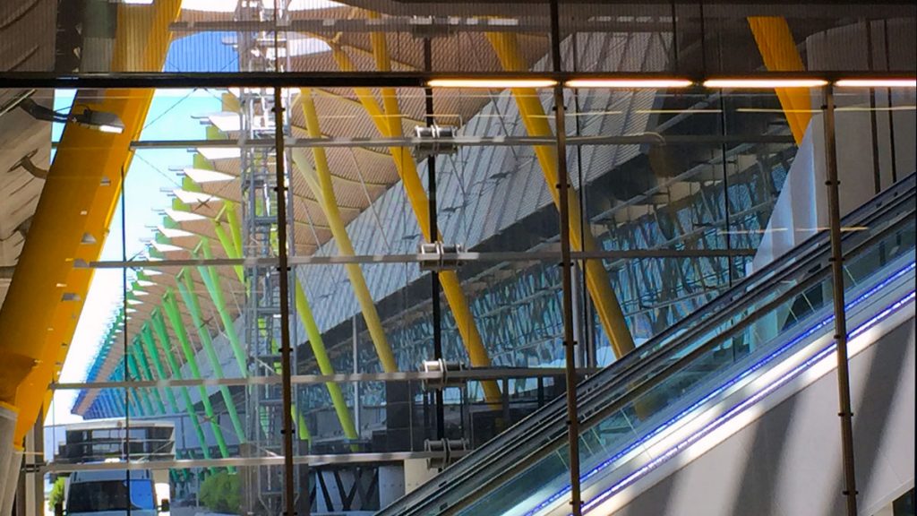 a glass wall with a yellow and green pole