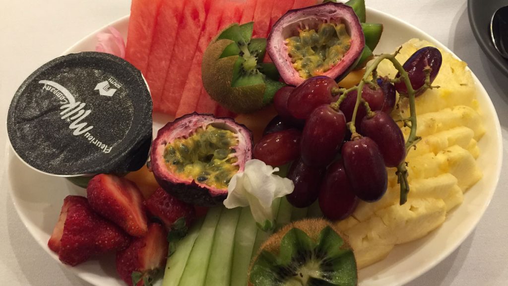 a plate of fruit on a white surface