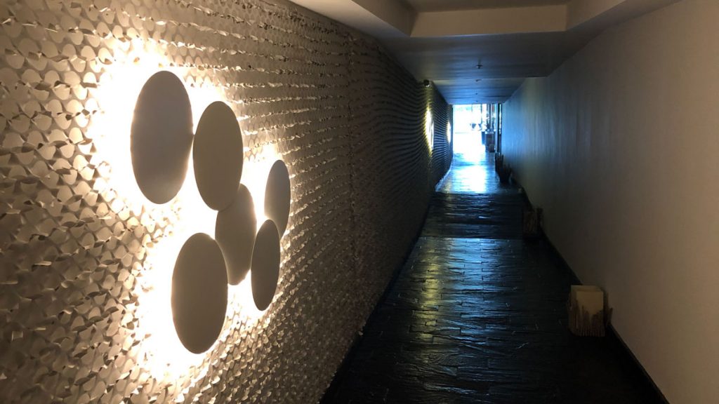 a hallway with white circles on the wall