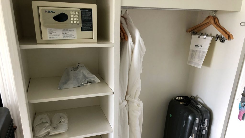 a white robe and a white robe on a shelf