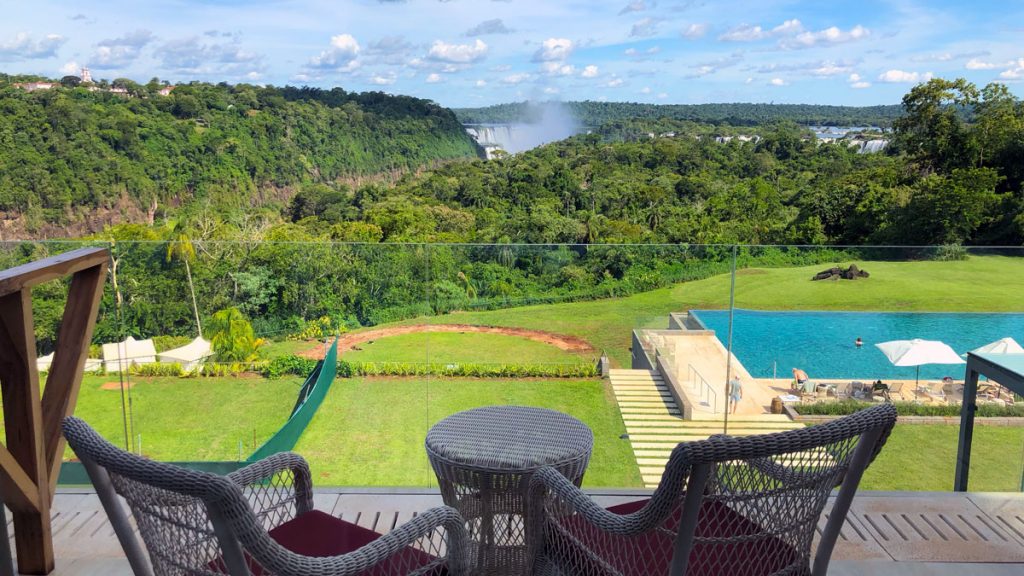 a view of a pool and a waterfall from a balcony