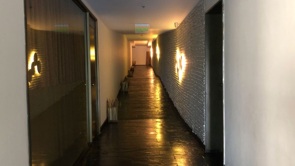 a hallway with lights on the wall