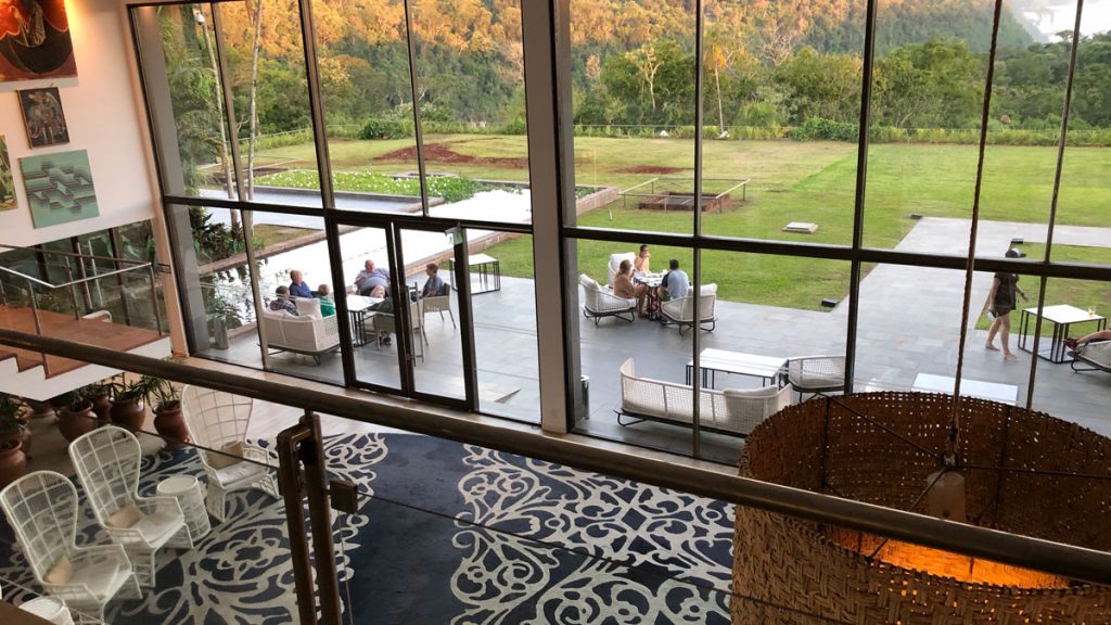 a group of people sitting on a patio outside a glass window