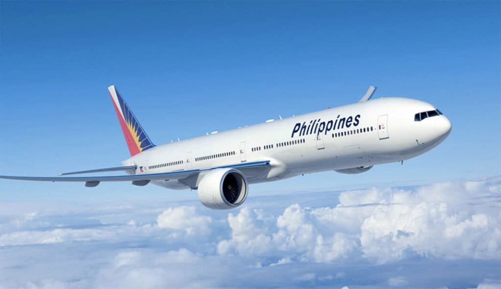 a white airplane flying in the sky
