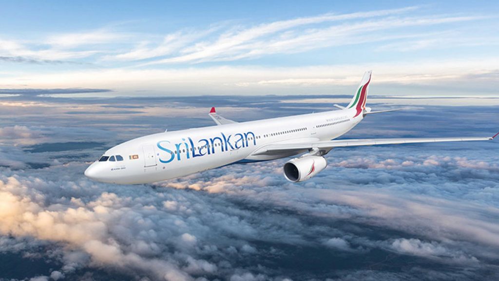 a white airplane flying above clouds