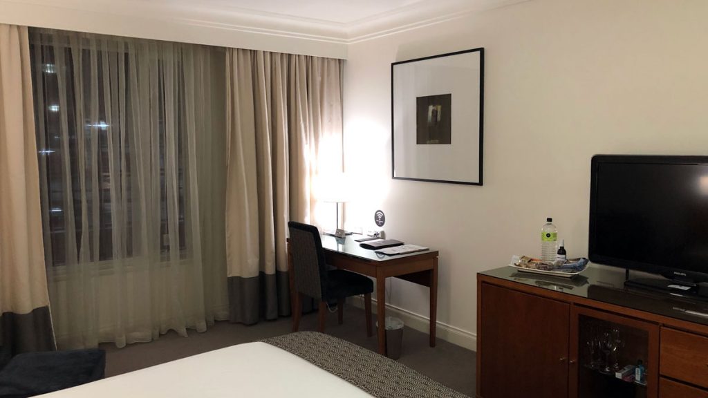 a desk and chair in a hotel room