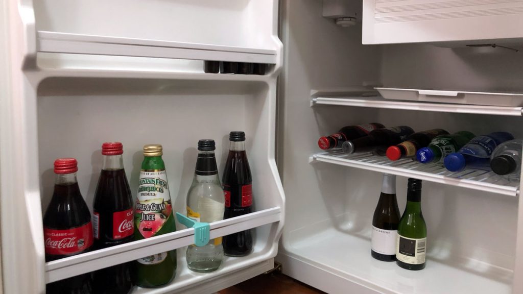 a refrigerator with bottles of liquid