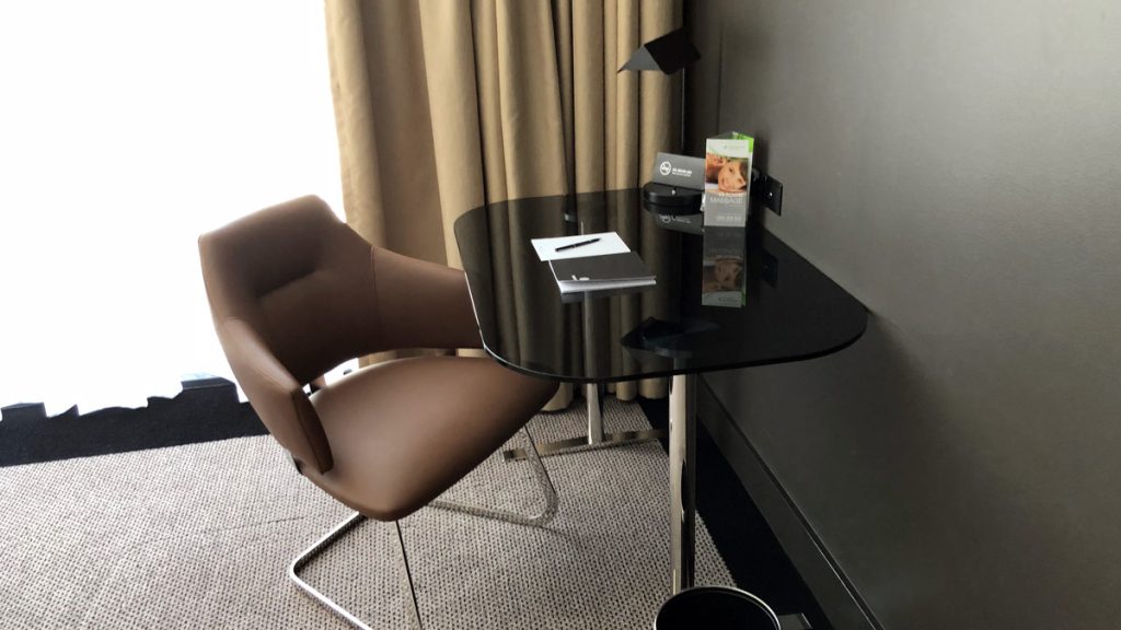 a desk with a chair and a book on it
