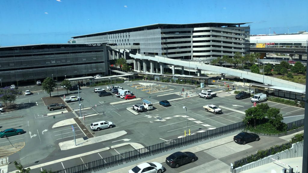 a parking lot with cars and a building