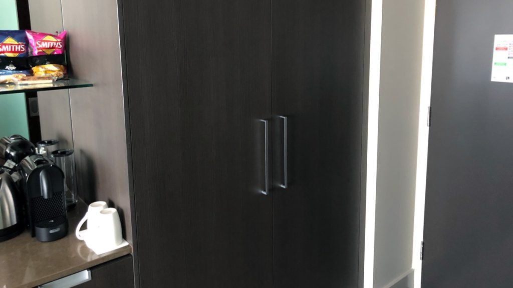 a black cabinet with silver handles