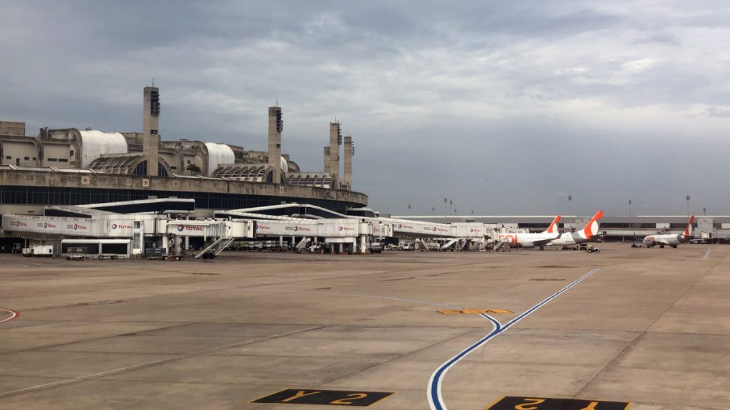 a group of airplanes parked in a terminal