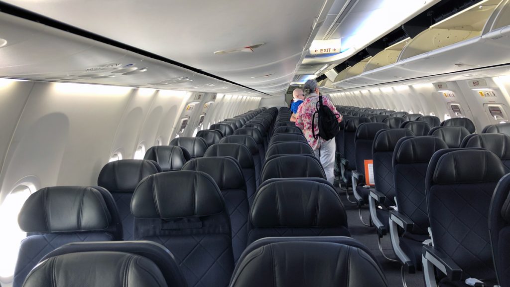 a group of people standing in an airplane