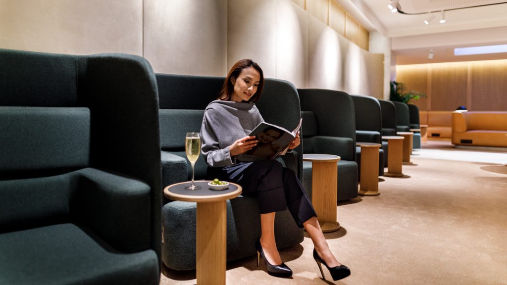 a woman sitting in a chair reading a book