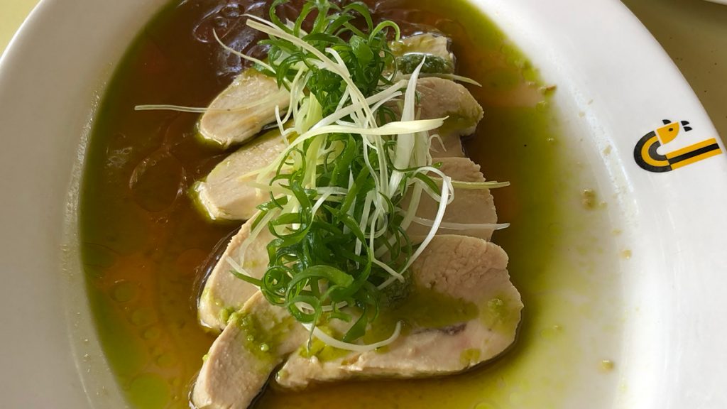 a bowl of soup with meat and green onions