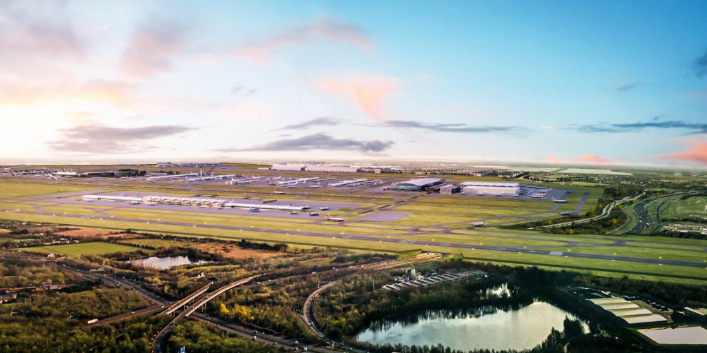 an aerial view of a runway and a lake