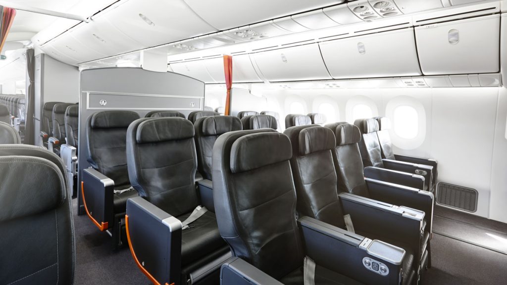 a row of black seats in an airplane