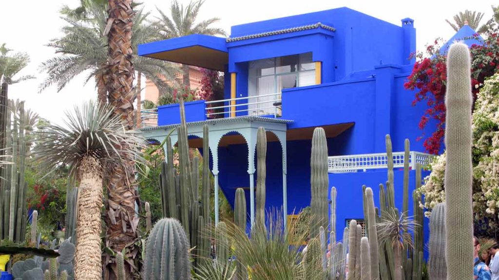 a blue house with cactuses