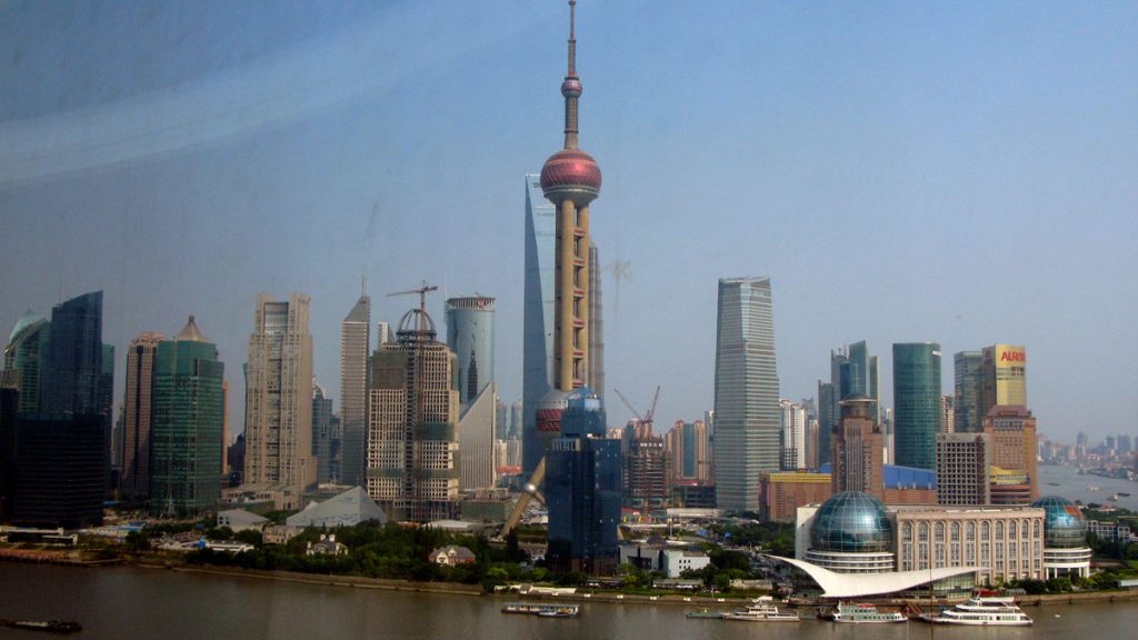 a city skyline with tall buildings and a body of water