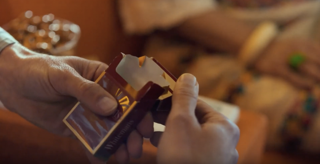 a person holding a box of playing cards