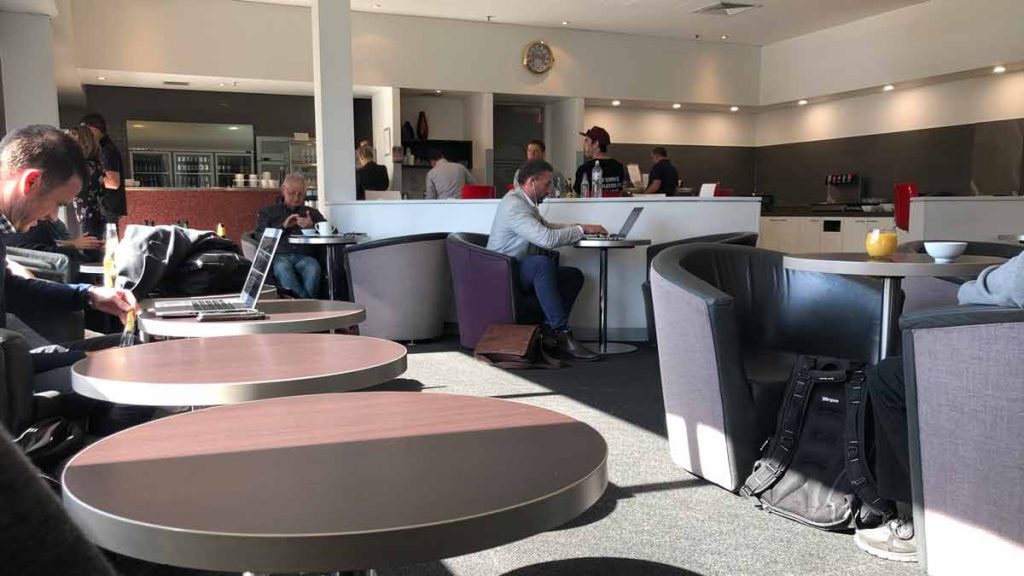 people sitting at tables in a cafe