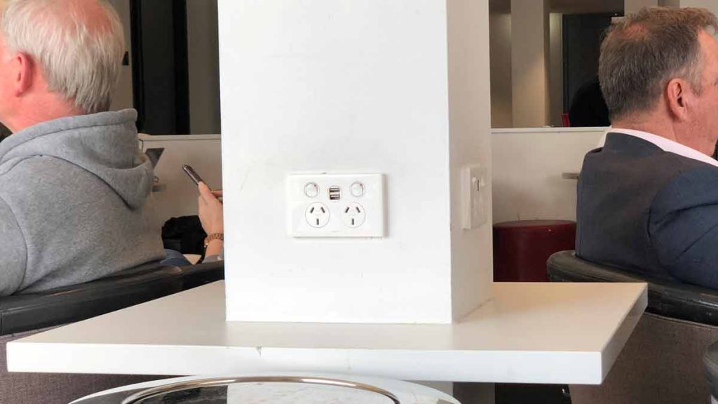 a white wall with a white outlet and a white wall