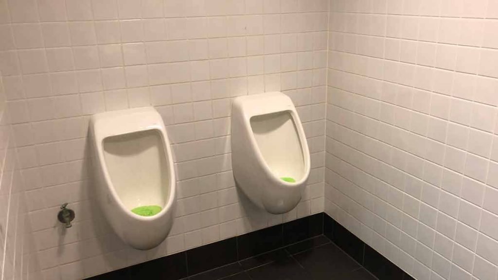 a couple urinals in a bathroom