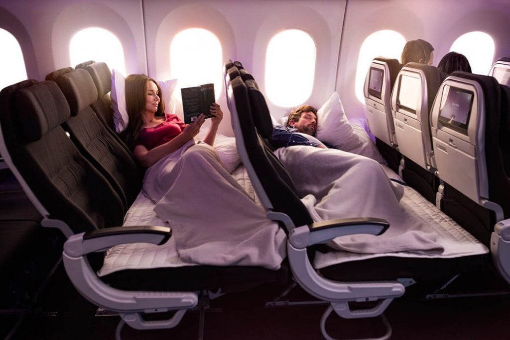 a woman reading a book in a plane