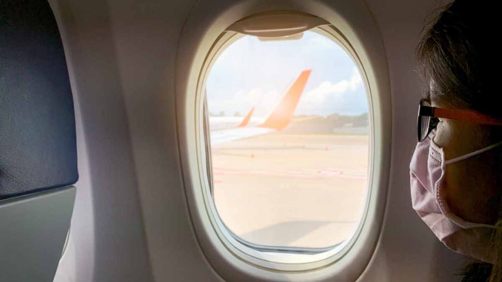 an airplane window with an airplane wing