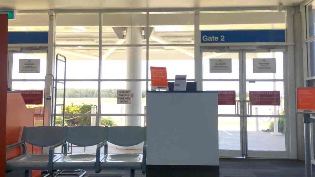 a waiting area with chairs and a sign