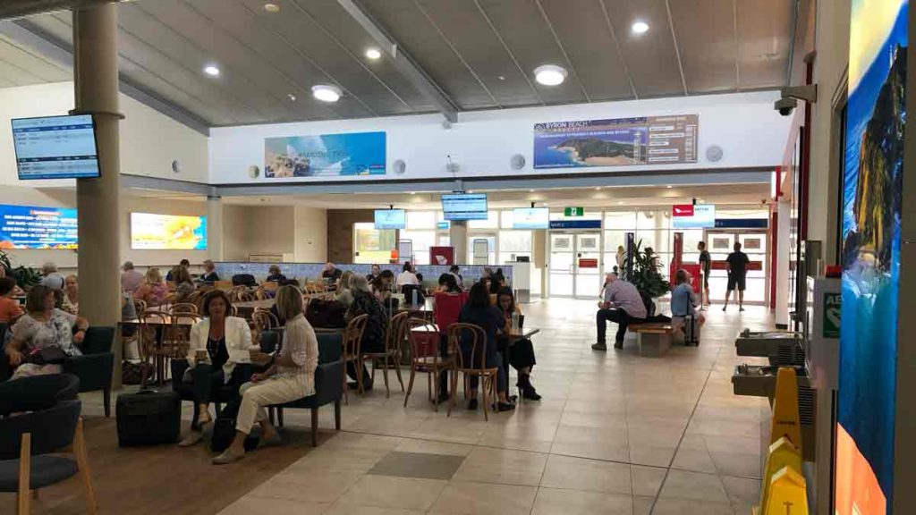 a group of people sitting at tables in a large room