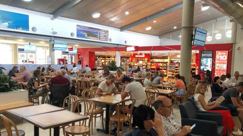 a group of people sitting at tables in a restaurant