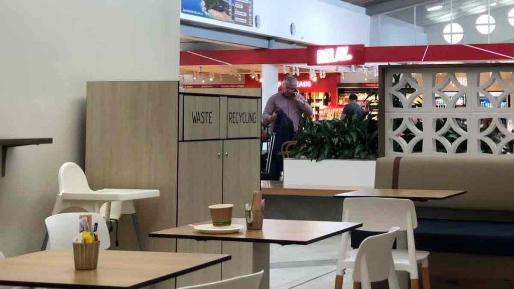 a man talking on a cell phone in a mall