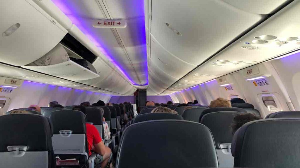 a plane with seats and people sitting