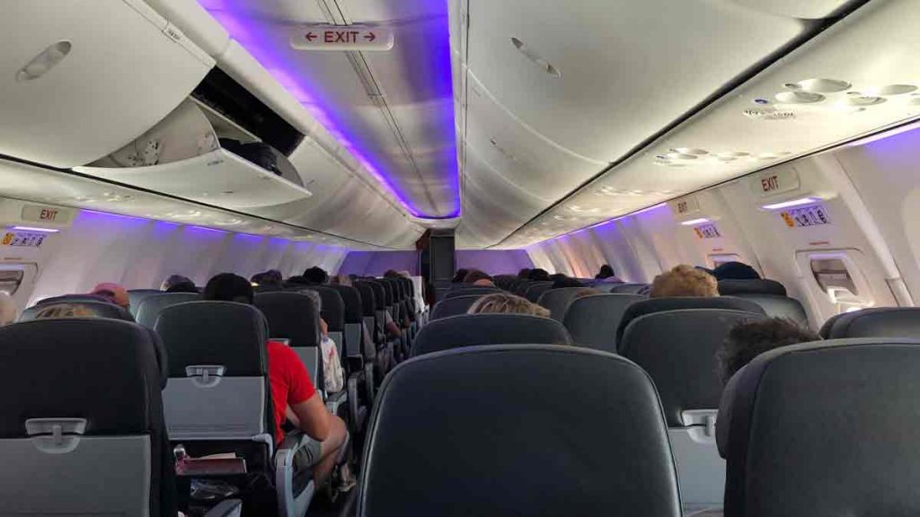 a group of people sitting in an airplane