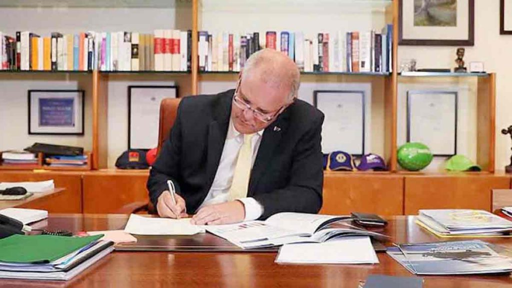 a man in a suit writing on a book