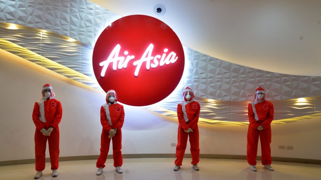 a group of people wearing red suits and face masks