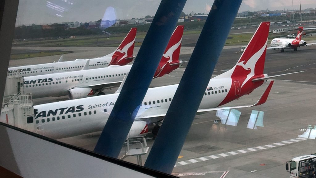 a group of airplanes on a runway