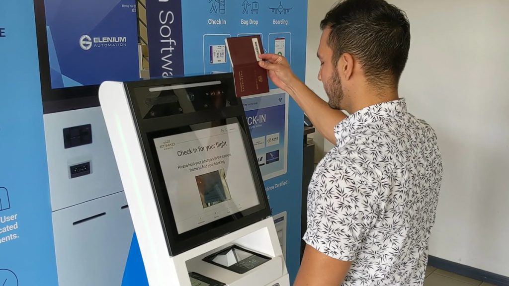 a man using a machine to check his tickets